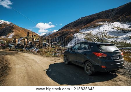 Ushguli Upper Svanetia Georgia - October 19 2016: Crossover car against the Svanetian Towers view in Ushguli in autumn. Roadtrip adventure in Georgia