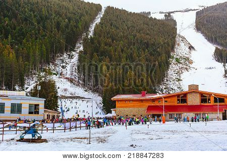 Bansko, Bulgaria - December 16, 2017: Ski resort panorama with ski lift, skiers on ski slopes, mountain view