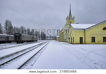 Deserted platform and railway station in the winter evening. City of Dno Pskov Oblast Russia