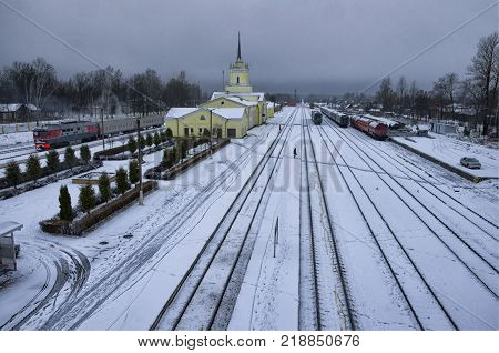 Deserted platform and railway station in the winter evening. City of Dno Pskov Oblast Russia