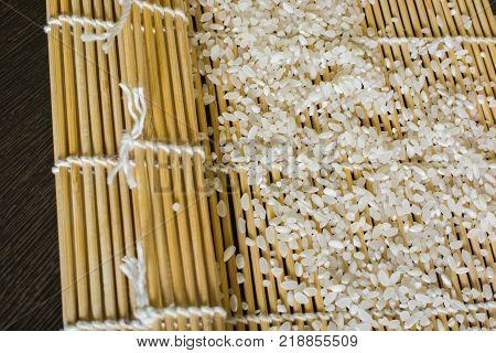 the rice is scattered on a rug for sushi