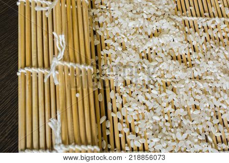 the rice is scattered on a rug for sushi