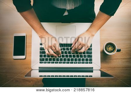 Woman sitting on the floor with laptop,smartphone and coffee cup.business,accounting concept.