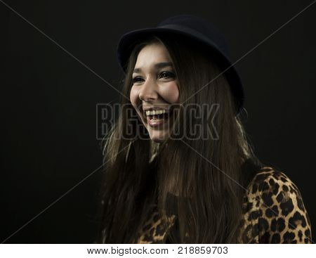 Beautiful Emotional Brunette Girl Laughting in the Studio. Close-up Portrait, studio shot