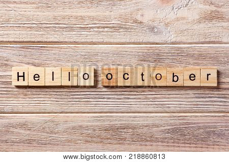Hello October word written on wood block. Hello October text on table concept.