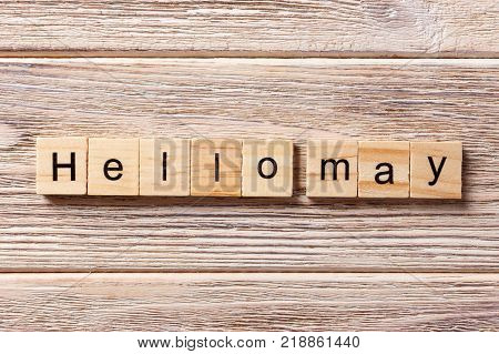 Hello May word written on wood block. Hello May text on table concept.