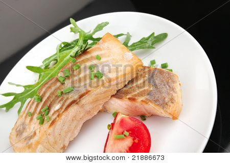 krydrede fisk del: ristede norske laksefilet garneret med rocula blade og tomater på w