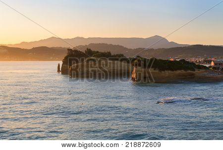 Rocks on the beach in the morning sunrise Corfu in Greece