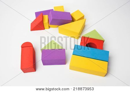 Mortgage and construction concept. House for family from multi-colored blocks on a white background.