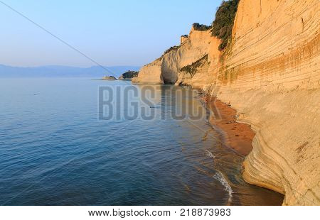 Rocks on the beach in the sunset on Corfu in Greece
