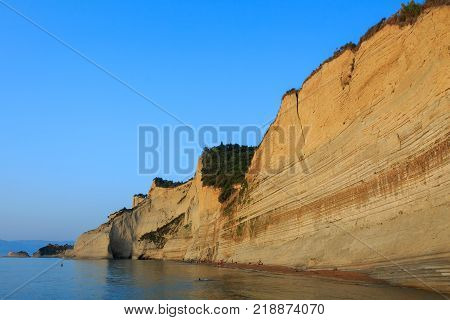 Rocks on the beach in the sunset on Corfu in Greece