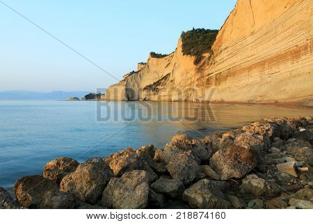Rocks on the beach in the sunset on Corfu in Greece
