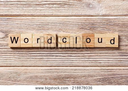 Word cloud word written on wood block. Word cloud text on table concept.