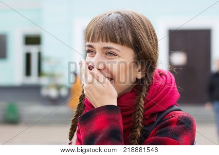 young beautiful girl covering her mouth with his hands for joy