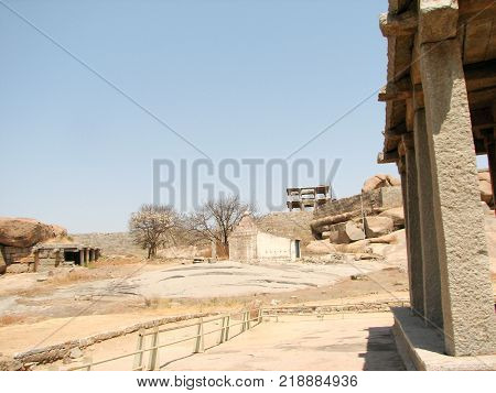View of ancient ruins on Hemakuta hill in Hampi, Karnataka, India. Landscape with unique mountain formation with amazing stones, tropical nature and temple. UNESCO World Heritage Site