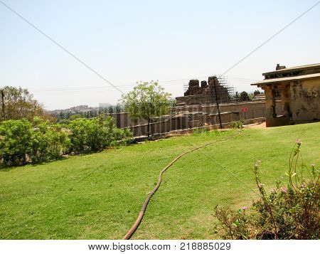 View of ancient ruins on Hemakuta hill in Hampi, Karnataka, India. Landscape with unique mountain formation with amazing stones, tropical nature and temple. UNESCO World Heritage Site
