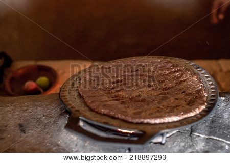 Hot homemade flatbread made of sorghum flour as a part of traditional rustic ethnic Srilankan cuisine