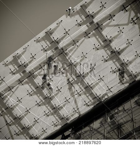 Fitters on a glass roof on a construction site in Berlin