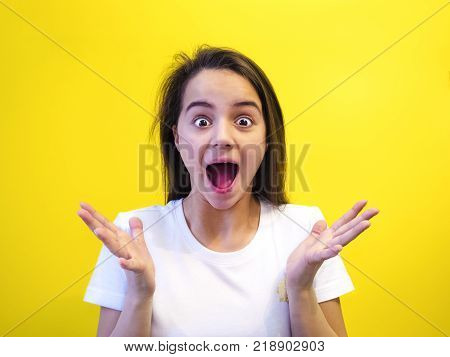 People, success, achievement and joy concept. Happy cheering female raises hands with excitement, screams YES, being lucky to reach goals, celebrates her victory, glad to recieve triumf