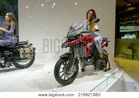 MILAN, ITALY - NOVEMBER 11, 2017: a model poses for the visitors during the EICMA 2017 - 75th International Motorcycle Exhibition.