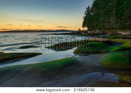 Scenic sunset view of the ocean overlooking the Strait of Georgia from Roberts Memorial Park in Nanaimo, British Columbia.