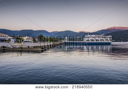 Port of Sami kefalonia ferry waiting for its passengers to make the journey to the Pisaetos mooring on the island of Ithaka and in the background the Kefalonia mountains Greece