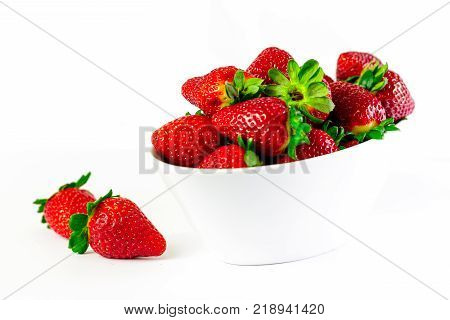 strawberry on white bowl with white background.