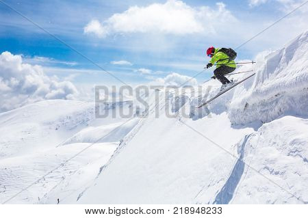 skier standing on top snow sunny day in Carpathian mountains Ukraine