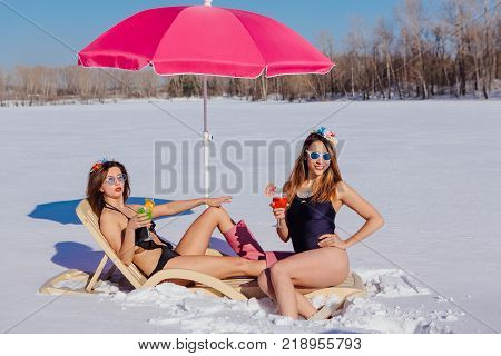 Novokuznetsk, Kemerovo region, Russia - 23 Feb, 2017 : White beaches of Siberia is an enterteiment activity where people playing beach games dressed in bikini in winter. Women in bikini with cocktails
