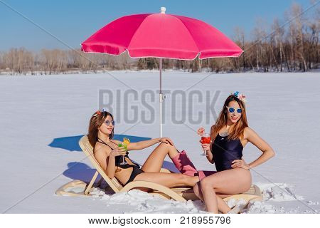 Novokuznetsk, Kemerovo region, Russia - 23 Feb, 2017 : White beaches of Siberia is an enterteiment activity where people playing beach games dressed in bikini in winter. Women in bikini with cocktails