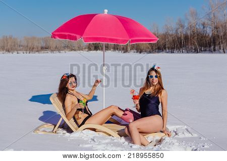 Novokuznetsk, Kemerovo region, Russia - 23 Feb, 2017 : White beaches of Siberia is an enterteiment activity where people playing beach games dressed in bikini in winter. Women in bikini with cocktails