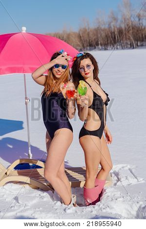 Novokuznetsk, Kemerovo region, Russia - 23 Feb, 2017 : White beaches of Siberia is an enterteiment activity where people playing beach games dressed in bikini in winter. Women in bikini with cocktails