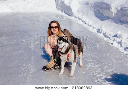 Novokuznetsk, Kemerovo region, Russia - 23 Feb, 2017 : White beaches of Siberia is an enterteiment activity where people playing beach games dressed in bikini in winter. Women in bikini with husky