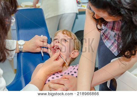 Portrait of sweet little girl with glasses and carefree expression on her face.