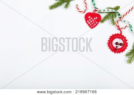 Christmas holiday composition. Festive creative red pattern, xmas handmade decor holiday with ribbon, candy canes, gift, christmas tree and decorations on white background. Flat lay, top view