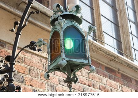 Gothic lantern on the facade of the old brick buildings