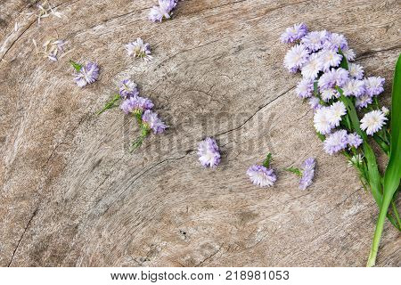Top view. flowers and rustic wood table.