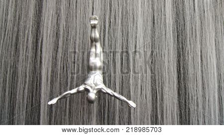 DUBAI, UNITED ARAB EMIRATES - MARCH 31st, 2014: Famous Waterfall in Dubai Mall world's largest shopping mall - 30m in diameter and 24 meters high with art fiberglass sculptures of human divers