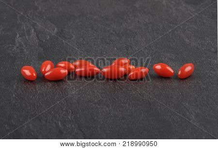 Colorful and crisp image of gojiberry in line on shale