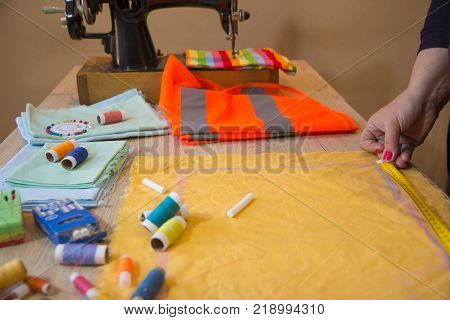 Tailor Hands notch tailor tailor's scissors cloth. Woman tailor working at a tailor shop. Garment industry tailoring concept