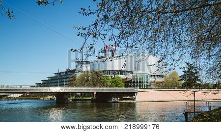 STRASBOURG FRANCE - APR 15 2017: European Court of Human Rights building and Ill River in Strasbourg France early in the morning on a spring day