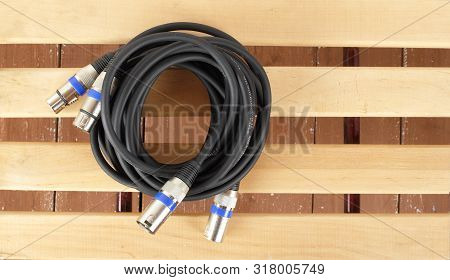 Music And Sound - Xlr Microphone Cable Professional On A Wooden Background.