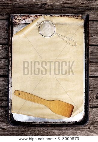 Old Vintage Baking Pan And Tins On Wooden Background. Selective Focus.