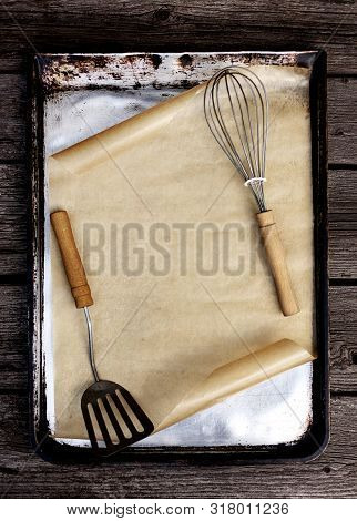 Old Vintage Baking Pan And Tins On Wooden Background. Selective Focus.