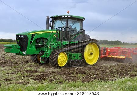 Cherkasy, Ukraine - May 18, 2018: Modern John Deere Tractor Model 8345rt Ploughing An Agricultural F