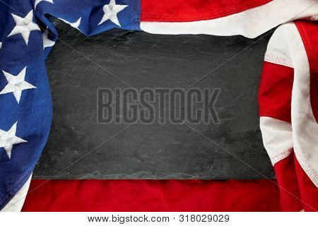 US American flag on black slate stone background. For USA Memorial day, Veteran's day, Labor day, or 4th of July celebration. With blank space for text.