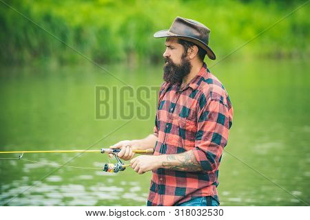 Brown Trout Being Caught In Fishing Net. Fly Fisherman Using Fly Fishing Rod In Beautiful River. Ang