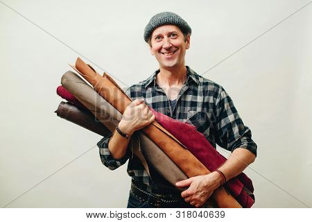 Happy Master Has Idea For New Leather Products. Tailor With Rolls Of Lether. Small Business And Entr