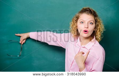 Student With Glasses At Blackboard. Girl Teacher At School Lesson. Back To School. Empty Blackboard.