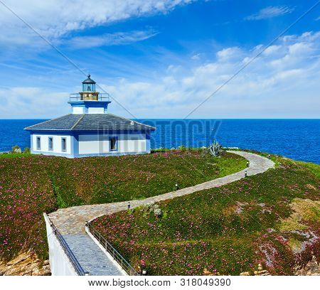Summer Ocean Island Pancha Coastline Landscape With Lighthouse And Pink Flowers (spain).